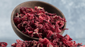 Dry hibiscus tea in wooden bowl. High quality photo