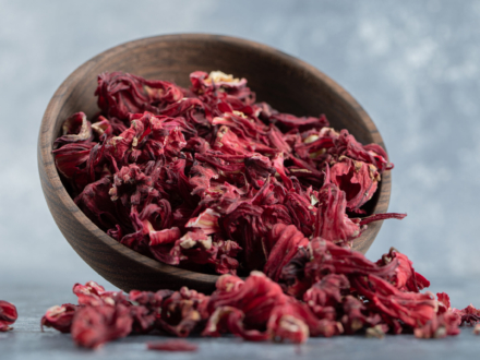 Dry hibiscus tea in wooden bowl. High quality photo
