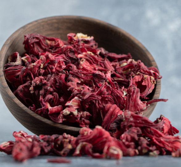 Dry hibiscus tea in wooden bowl. High quality photo